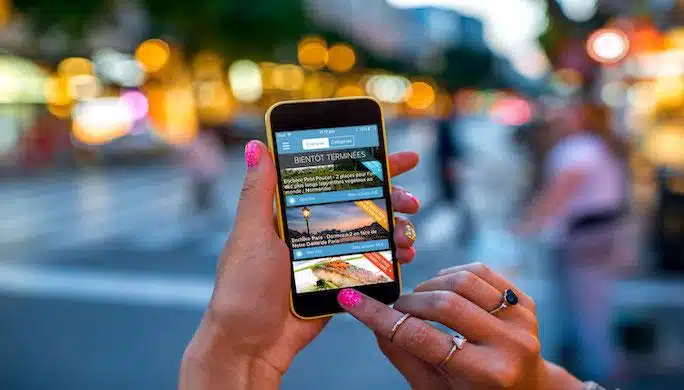 Holding phone on street background