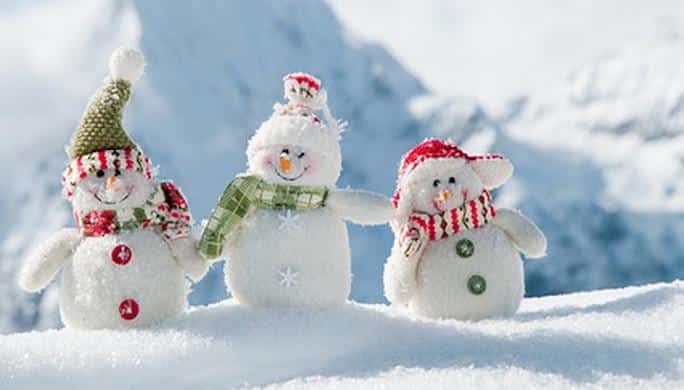 Happy snowmans in mountain