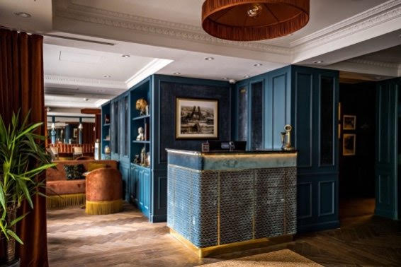 entrée de l'hôtel avec comptoir d'accueil bleu