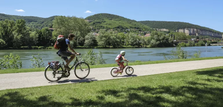père et enfant à vélo fleuve végétation