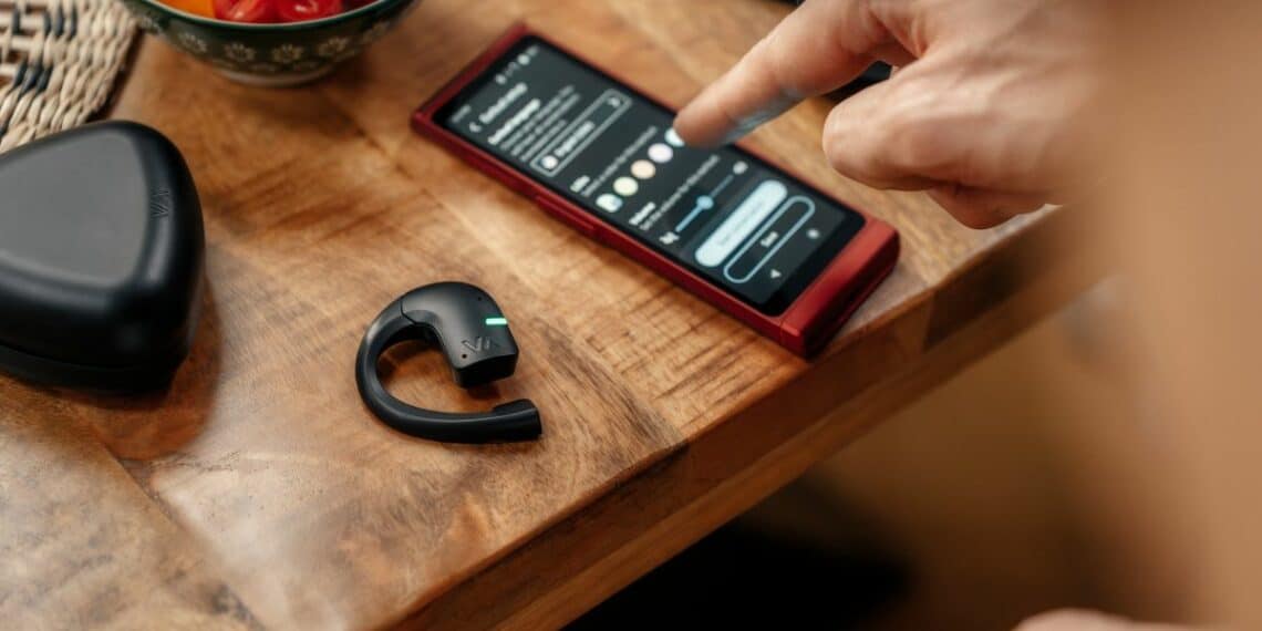 téléphone portable et écouteur posé sur une table en bois