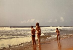 Photo de famille à Grand Bassam Trois personne sur une plage de sable au bord de la mer. Une photo ancienne
